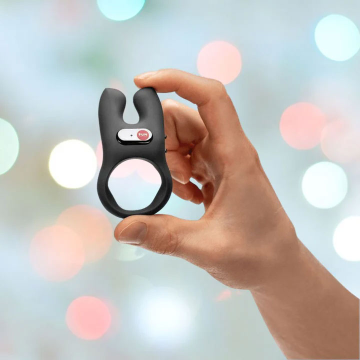 an image of a man holding a cock ring